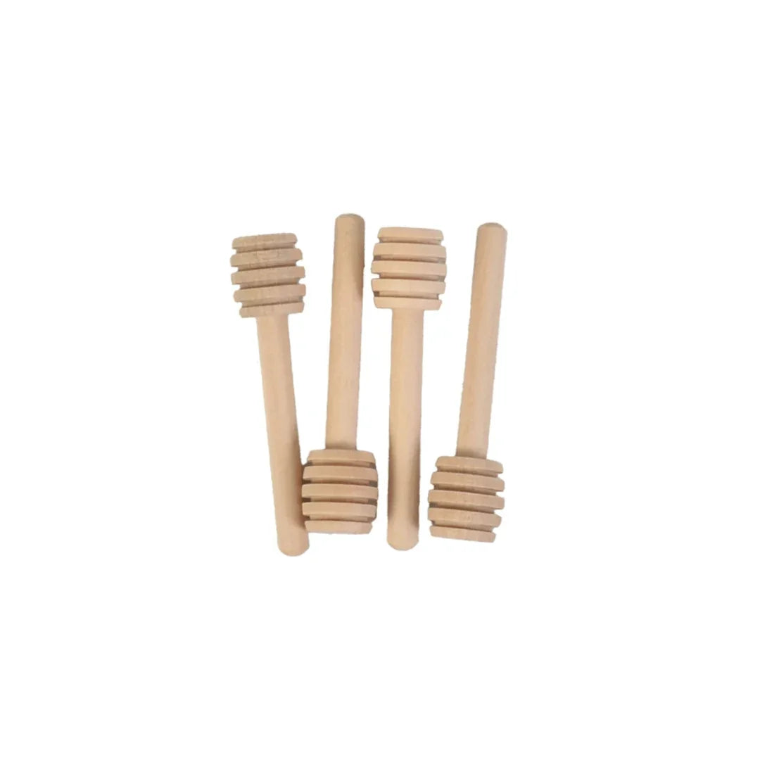 Four small wooden honey dippers arranged vertically on a white background