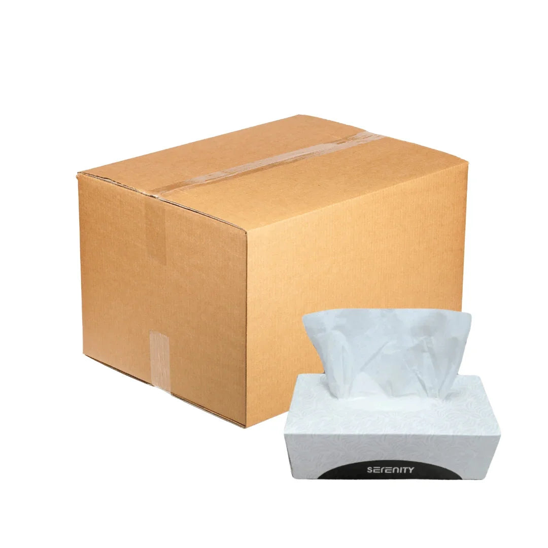 A large brown cardboard shipping box next to a white Serenity brand facial tissue box.