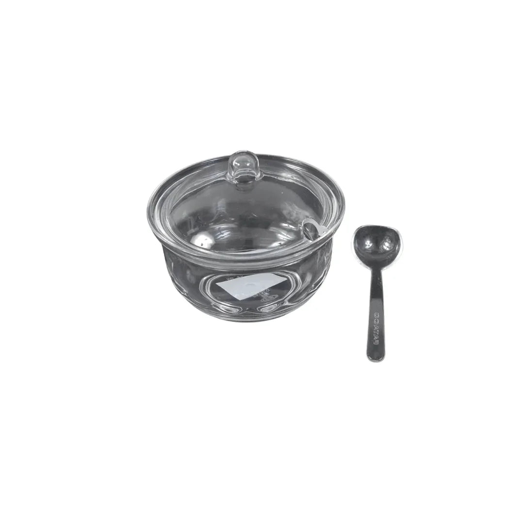 Clear glass condiment bowl with lid and matching small serving spoon
